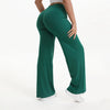 A person wearing dark green NCLAGEN SoftMotion straight leg yoga pants.