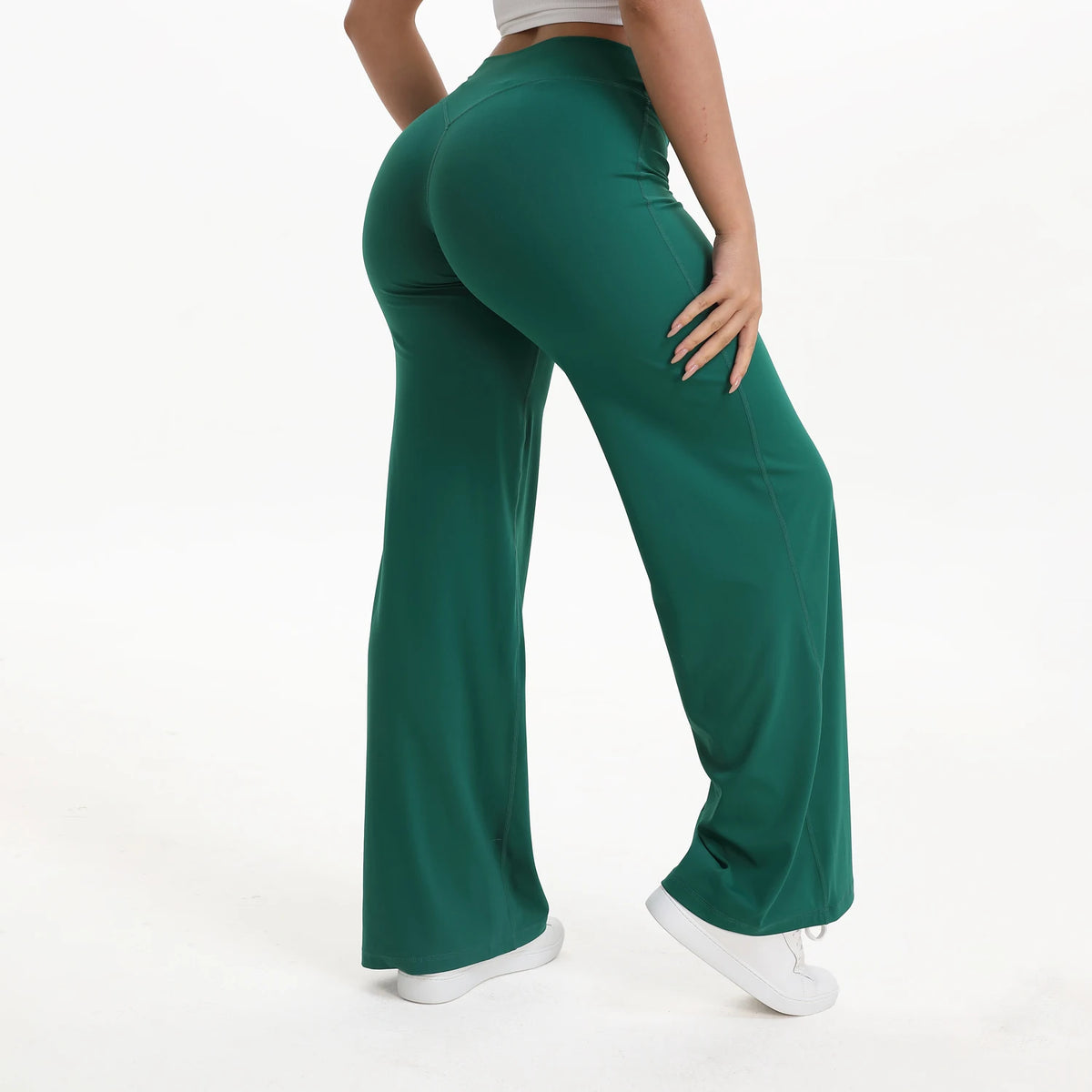 A person wearing dark green NCLAGEN SoftMotion straight leg yoga pants.