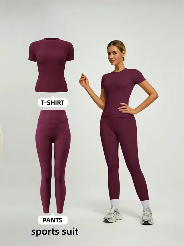 A model wearing a maroon sports suit consisting of a short-sleeved top and leggings.