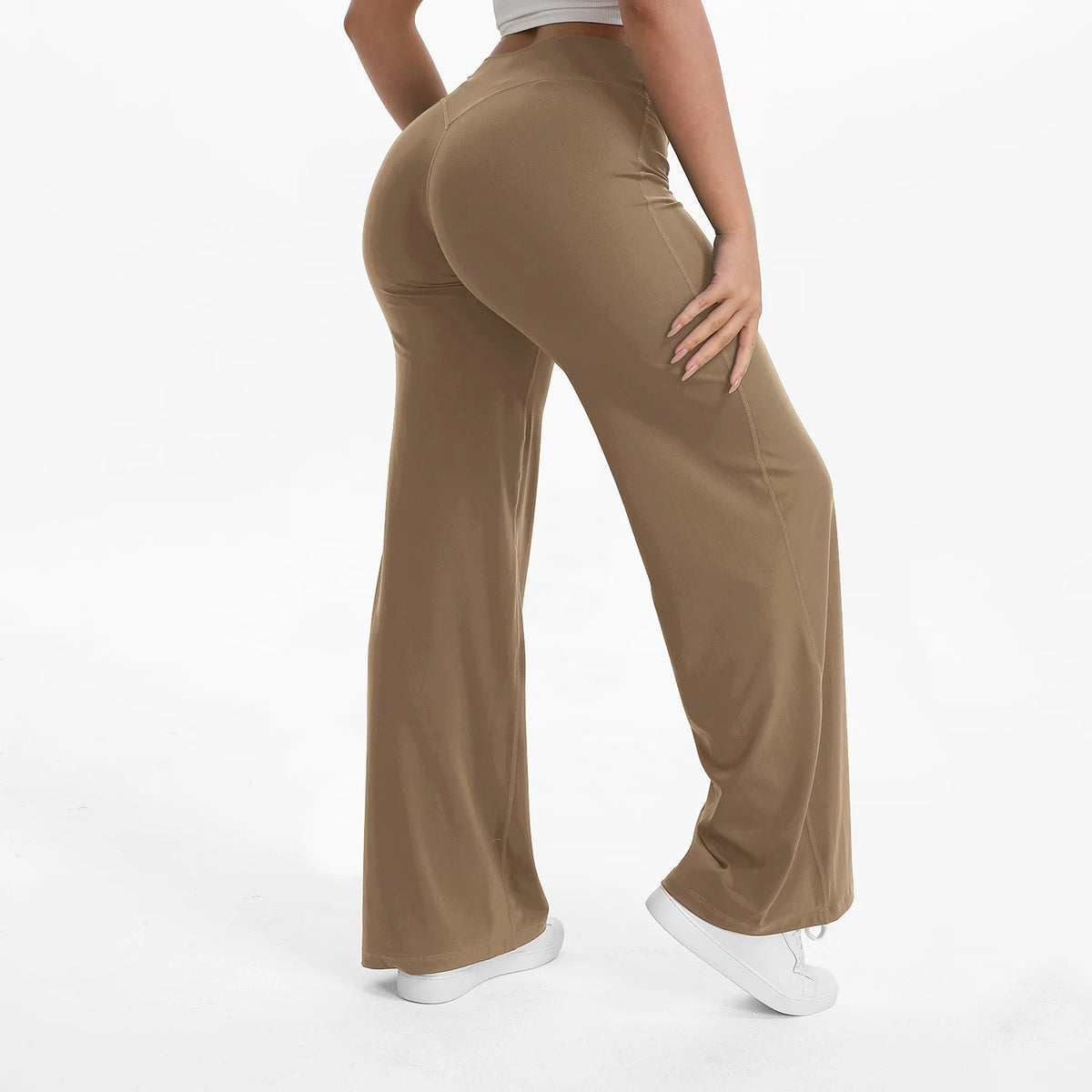 A person is modeling tan NCLAGEN SoftMotion Straight Leg Yoga Pants in a neutral tone.