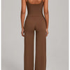 A woman wearing a brown high-waist yoga and fitness tracksuit set from the back view.