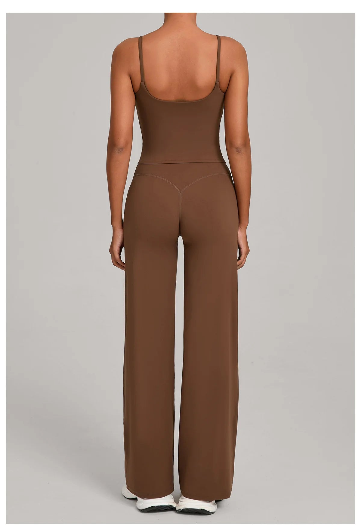 A woman wearing a brown high-waist yoga and fitness tracksuit set from the back view.