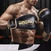 A close-up of a muscular man wearing black boxing gloves with gold accents, demonstrating pro boxing training equipment.