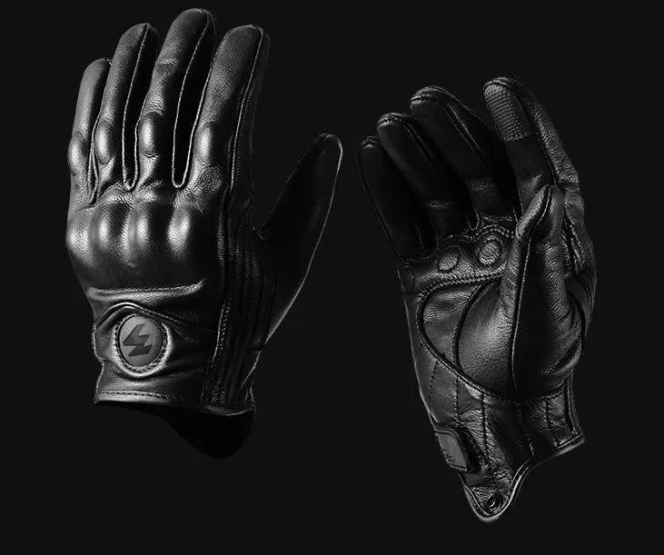 A pair of black full finger leather motorcycle riding gloves displayed against a dark background.