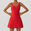 Une mannequin portant une robe de sport rouge deux pièces, vue de face.