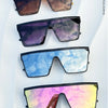 A collection of four pairs of retro square sunglasses in various shades of brown, purple, blue, and pink.