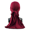 A deep maroon men's distressed pirate style durag head wrap tied around a mannequin neck.