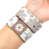 A wristband bracelet featuring a gray and white floral pattern on a stretch silicone material.