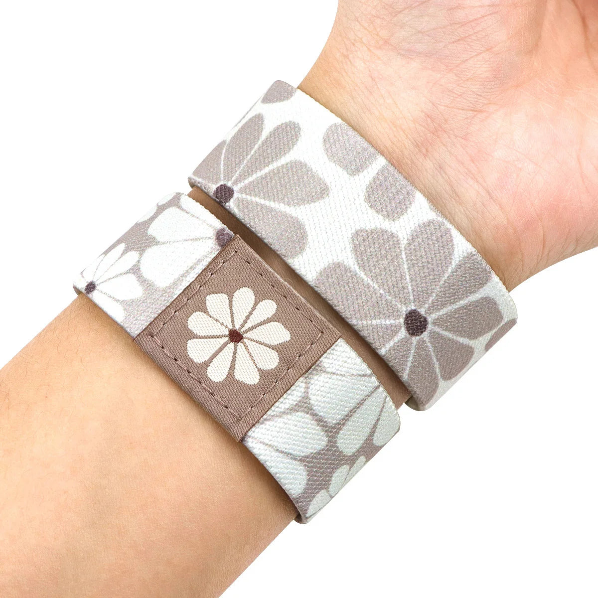 A wristband bracelet featuring a gray and white floral pattern on a stretch silicone material.
