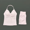 A white women's seamless backless fitness set consisting of a cropped top and matching shorts.