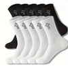 A set of black and white men's high-cut breathable casual crew socks laid out for display.