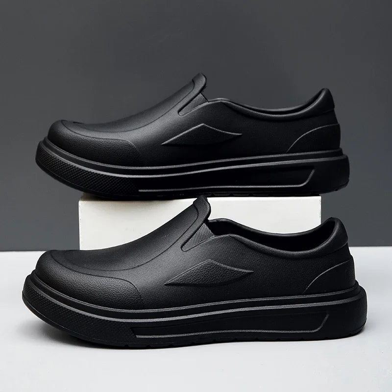 A pair of black men's anti-slip oil-resistant kitchen clogs shown from the side.