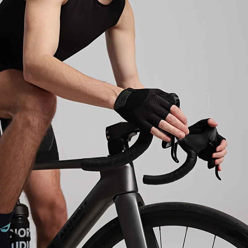A person wearing black cycling gloves is gripping the handlebars of a bicycle.