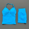 A bright blue women's seamless fitness set consisting of a cropped top and matching shorts.