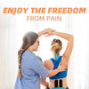A woman applies kinesiology tape to another woman's arm for athletic recovery.