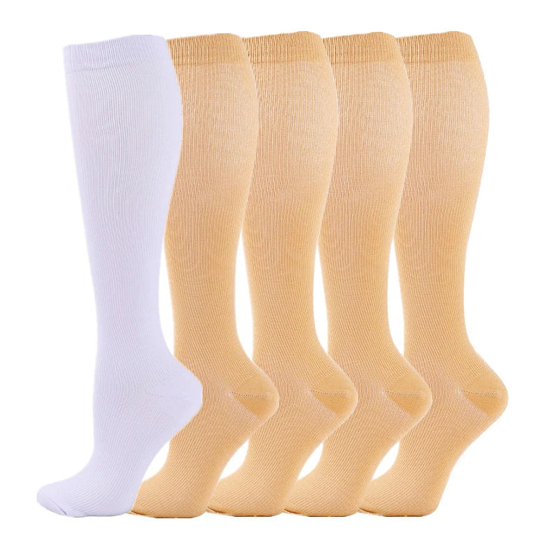 A row of medical grade compression socks in various shades of beige and white.