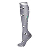 Gray compression socks with a black and white cow print pattern.