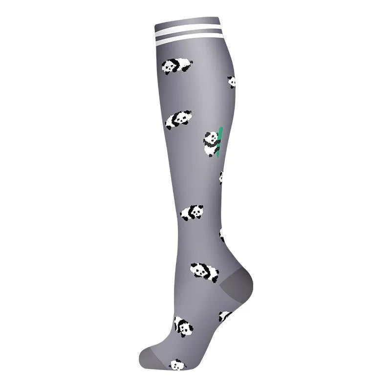Gray compression socks with a black and white cow print pattern.