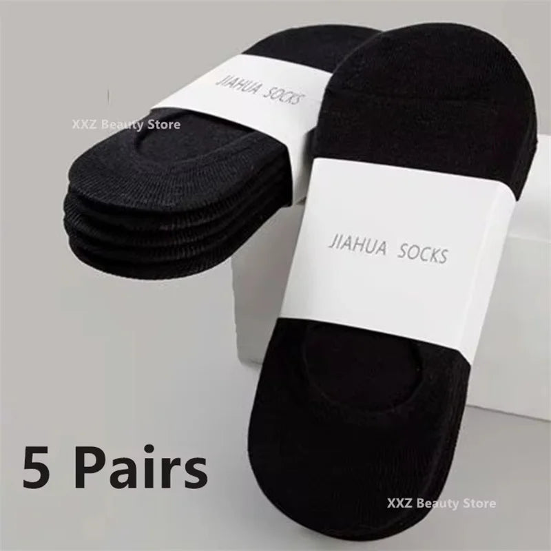Five pairs of black invisible silicone no-show boat socks displayed on a white background.