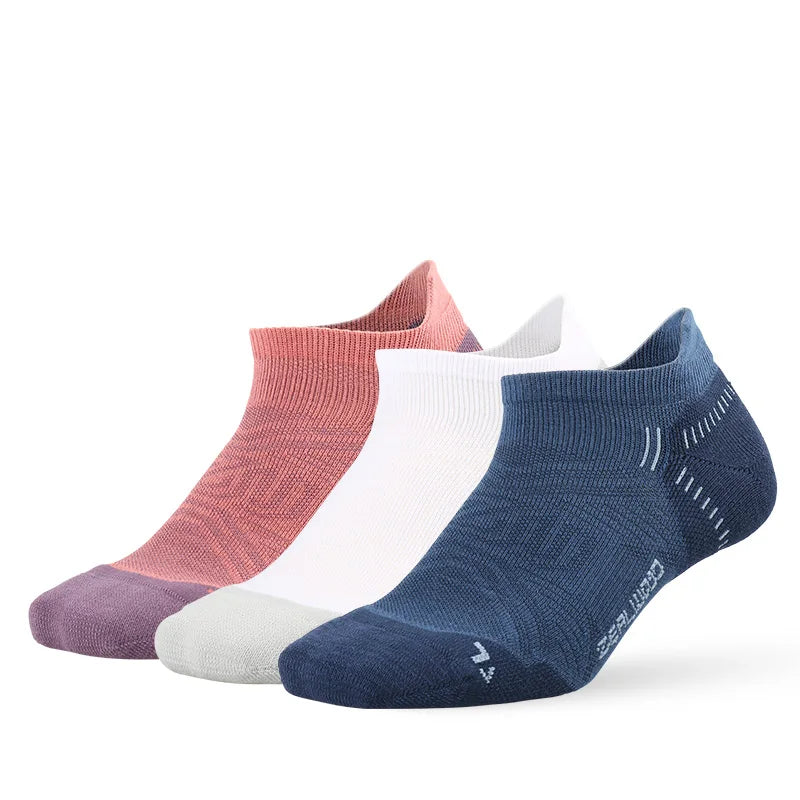 A collection of breathable performance running socks in various shades including pink, white, and navy blue.
