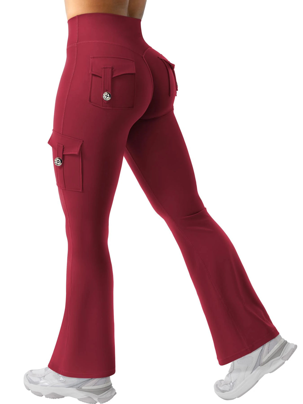A model is wearing high-waisted maroon fitness pants with cargo pockets and a matching gray athletic shoe.