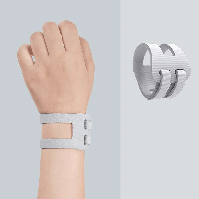 A close-up of a hand wearing a light gray elastic pressure wrist strap for carpal tunnel relief.