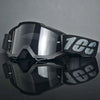 Un par de gafas de motocross negras con lentes ahumados y una correa negra