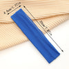 A blue stretchable cotton sweat absorbing headband is shown lying on a beige knitted fabric.