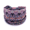 A close-up of a dark patterned bohemian stretch cotton headband rolled into a coil.