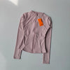 A mauve quick-dry yoga and fitness jacket is displayed against a light gray background.
