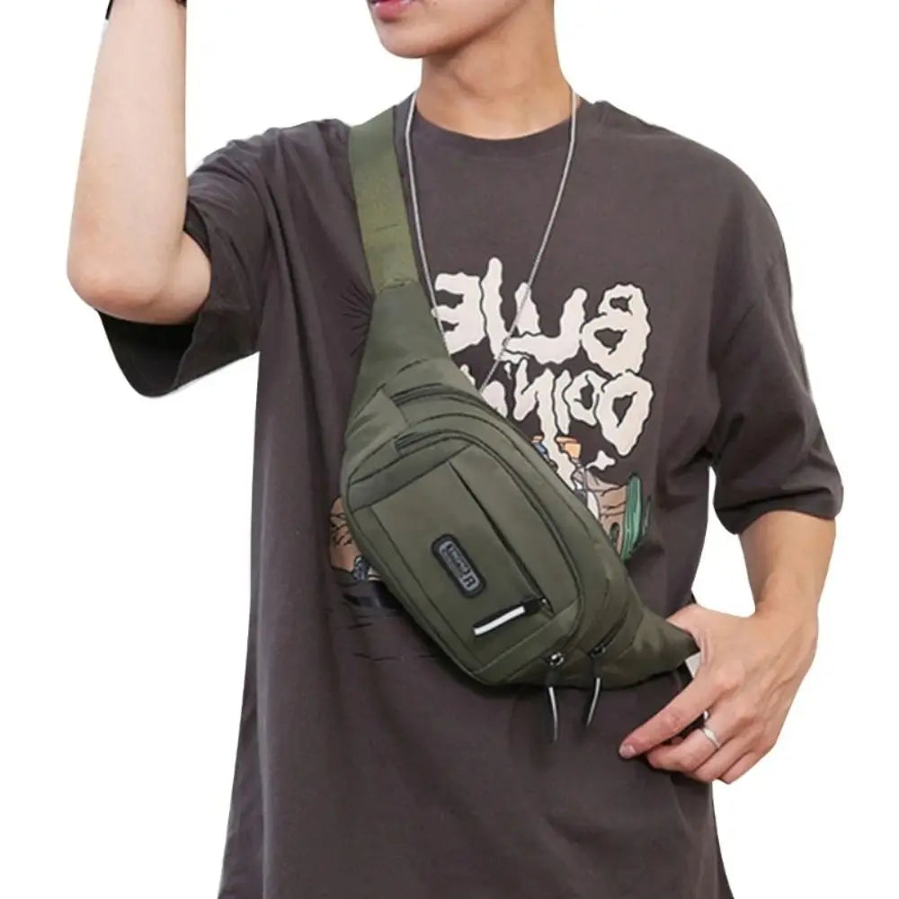 A man wearing a dark t-shirt with a green nylon waist bag slung across his chest.