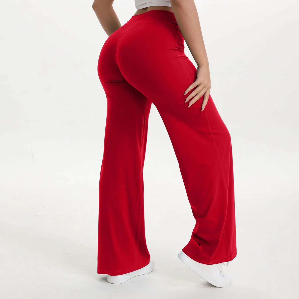 A person is modeling red NCLAGEN SoftMotion Straight Leg Yoga Pants from the side.