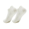 A pair of white women's yoga and fitness socks shown from above.
