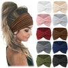 A collection of boho wide turban headbands in various shades of pink, gray, brown, and blue, shown folded.