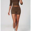 A model wearing a solid brown women's yoga and fitness leggings set, shown in full body shots.