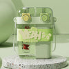 A clear double-walled drinking cup with a straw and a lime green lid featuring a cute lion design.