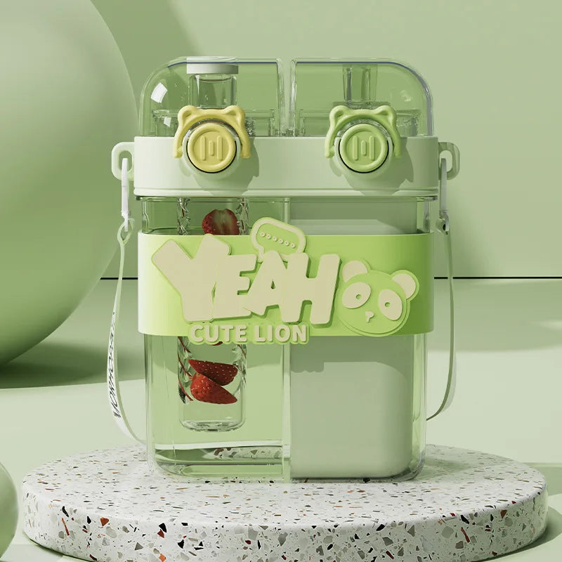 A clear double-walled drinking cup with a straw and a lime green lid featuring a cute lion design.