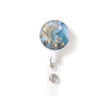 A round, blue and gold marbled charm attached to a clear plastic keychain.