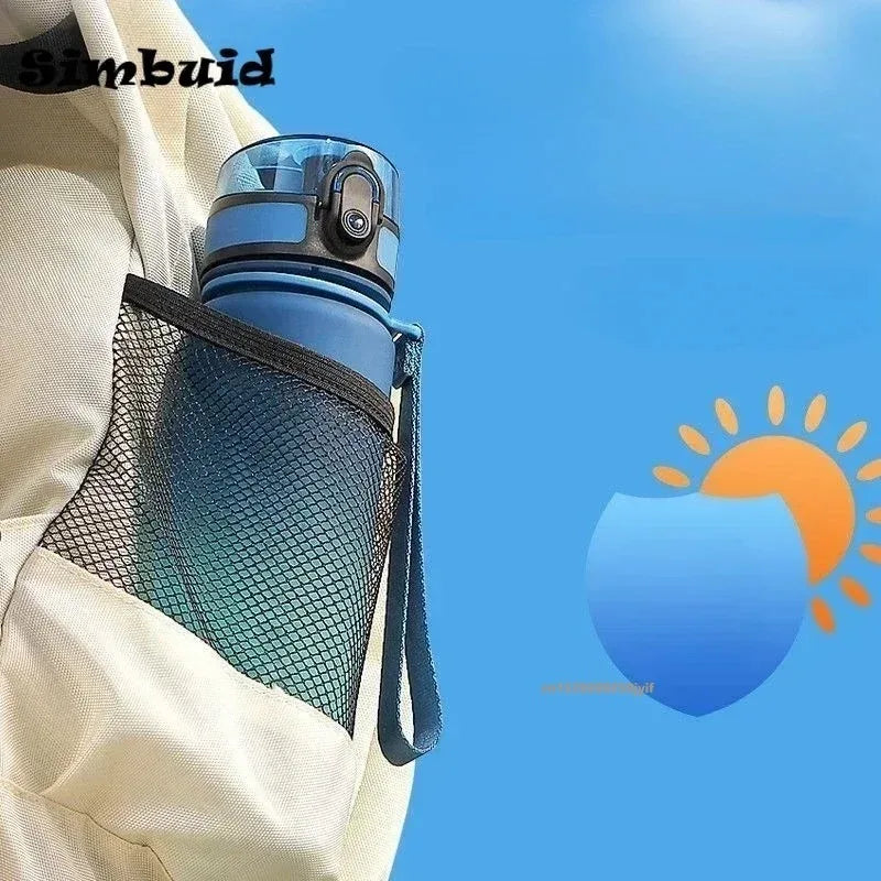A gradient insulated sports water bottle with a mesh sleeve is shown against a blue sky background.