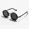 A pair of black polarized round sunglasses with adjustable dimming features.