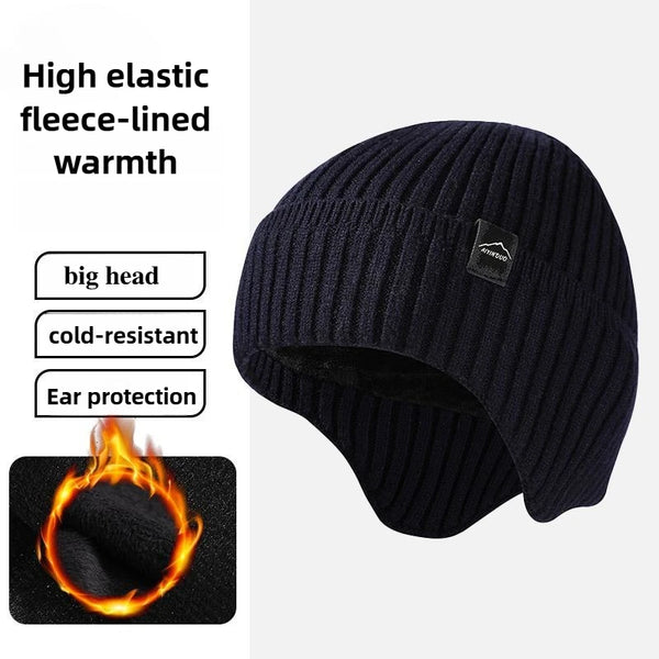 A dark navy knitted winter hat with a pom-pom, designed for warmth and ear protection.