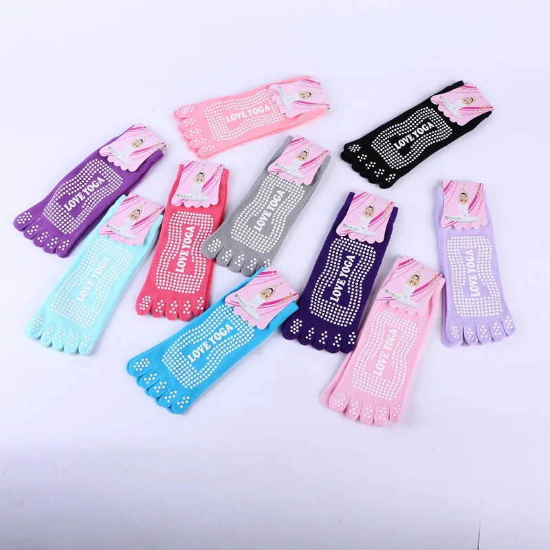 A collection of colorful yoga socks in various shades including pink purple blue and black