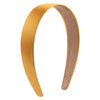 A curved satin hair band in a golden yellow color with a suede-colored inner lining.