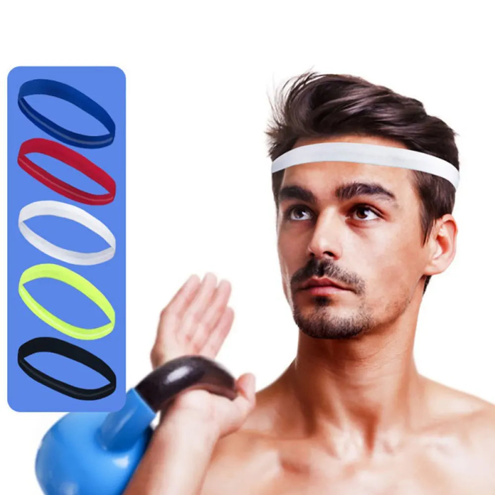 A man wearing a white sports headband while holding a blue bottle and a multi-color silicone band.