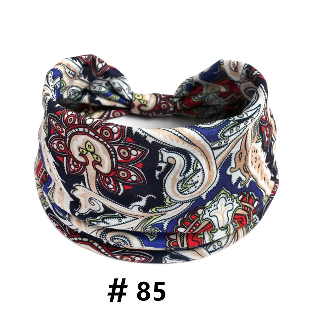 A close-up of a patterned boho print cotton headband tied in a knot.