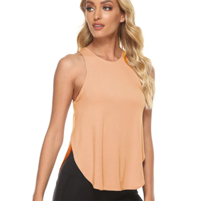 A woman models a peach-colored quick-dry yoga and gym tank top.