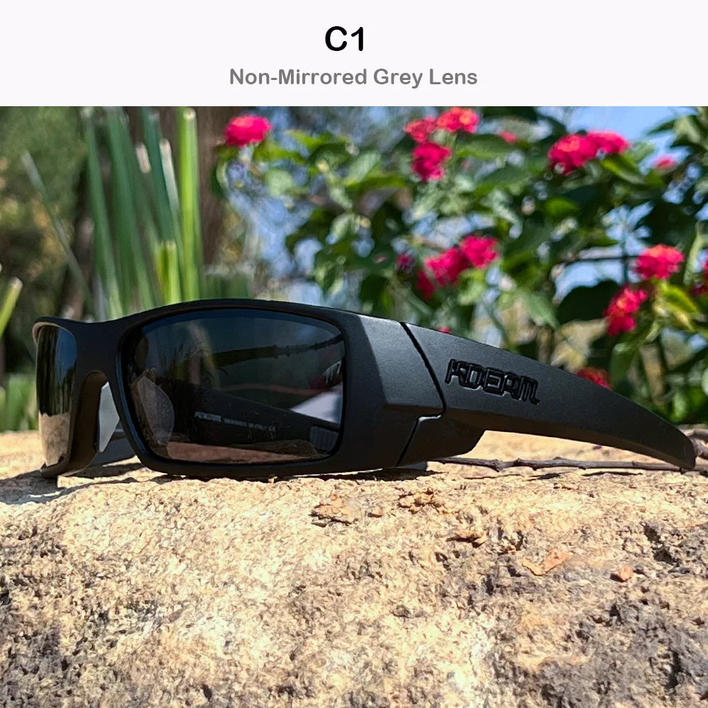 Black non-mirrored grey lens sunglasses resting on a textured rock outdoors.