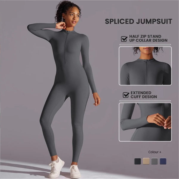 A model wearing a grey spliced jumpsuit with a half zip stand up collar and extended cuff design.