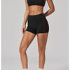 A woman models a black two-piece yoga and sports tracksuit set with red accents.