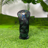 Black golf club head cover featuring a silhouette of a golfer and the text CHANGE 1961 placed on green grass.